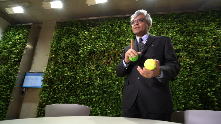 Prof. Sarkar holding tennis ball and wiffle ball