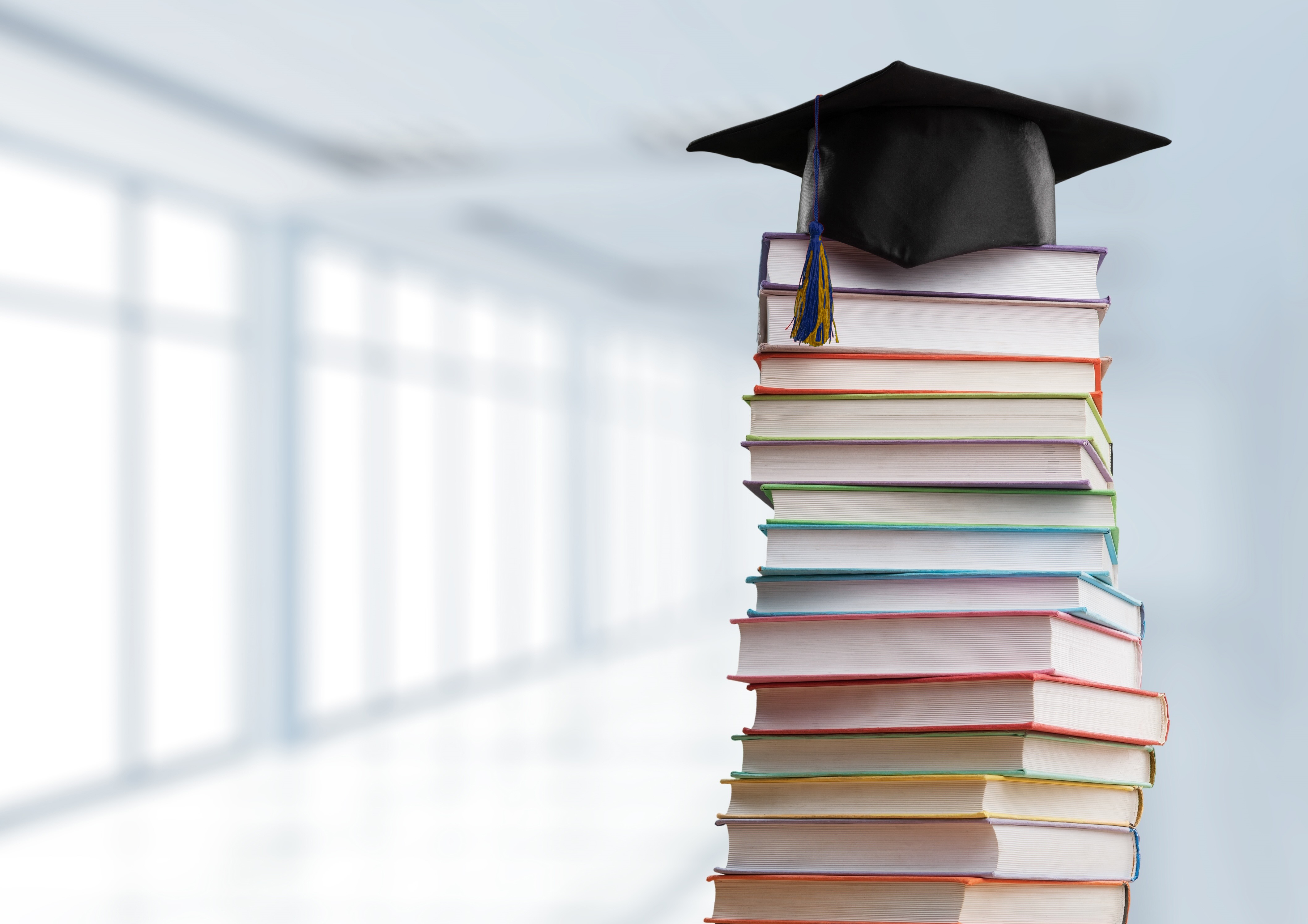 Stack of books with grad cap ontop