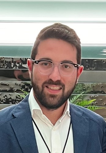 Faculty member in a blue blazer and white collared shirt