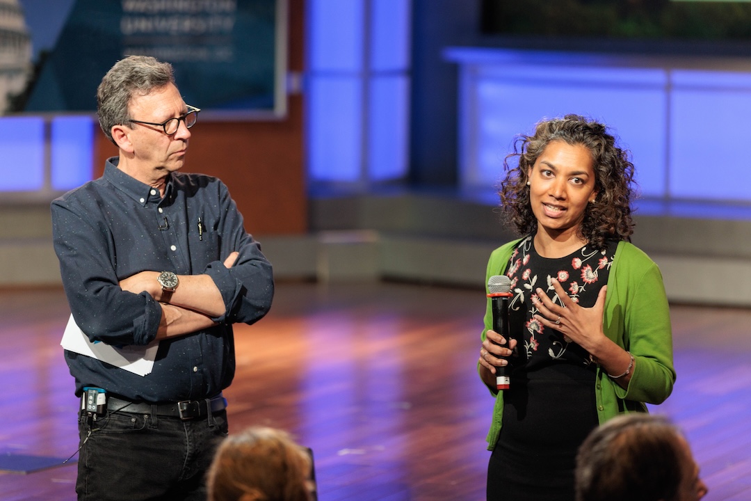 Two people in an auditorium 