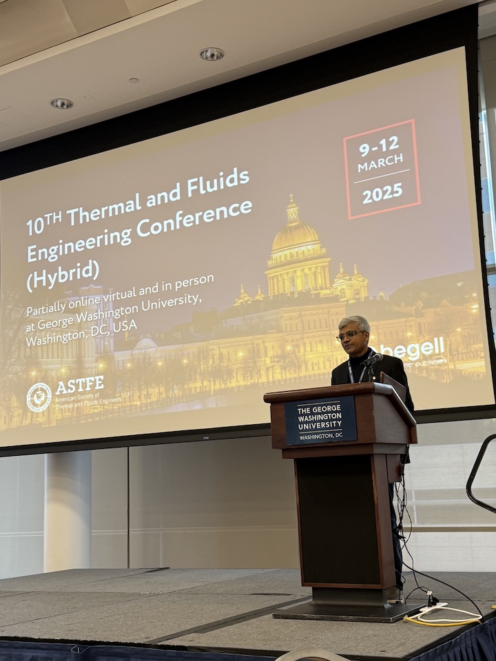 Man presenting at a podium  