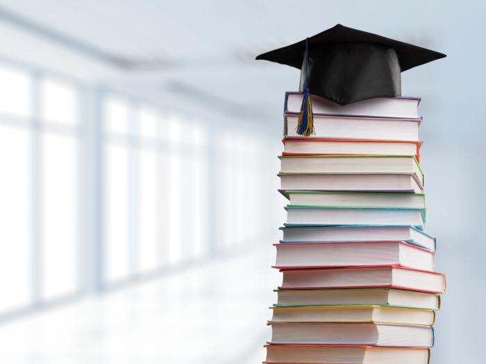 Stack of books with grad cap ontop