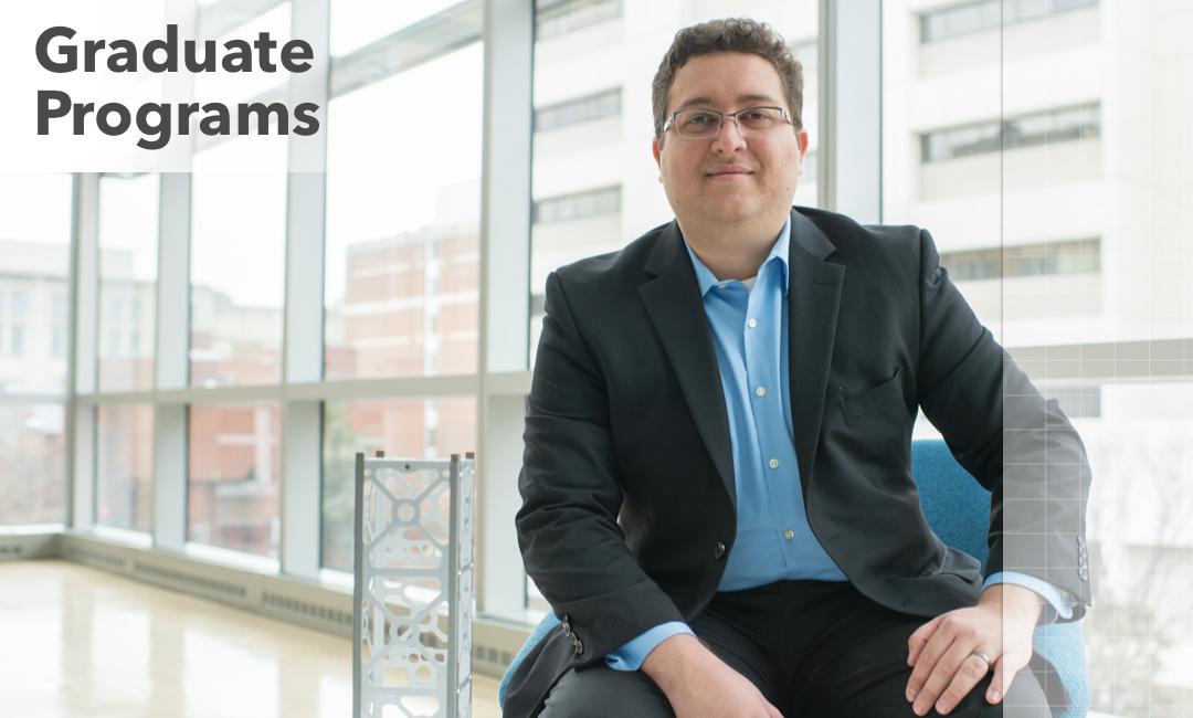 student sitting in the Science and Engineering Hall; text says Graduate Programs