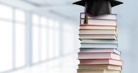 Stack of books with grad cap ontop